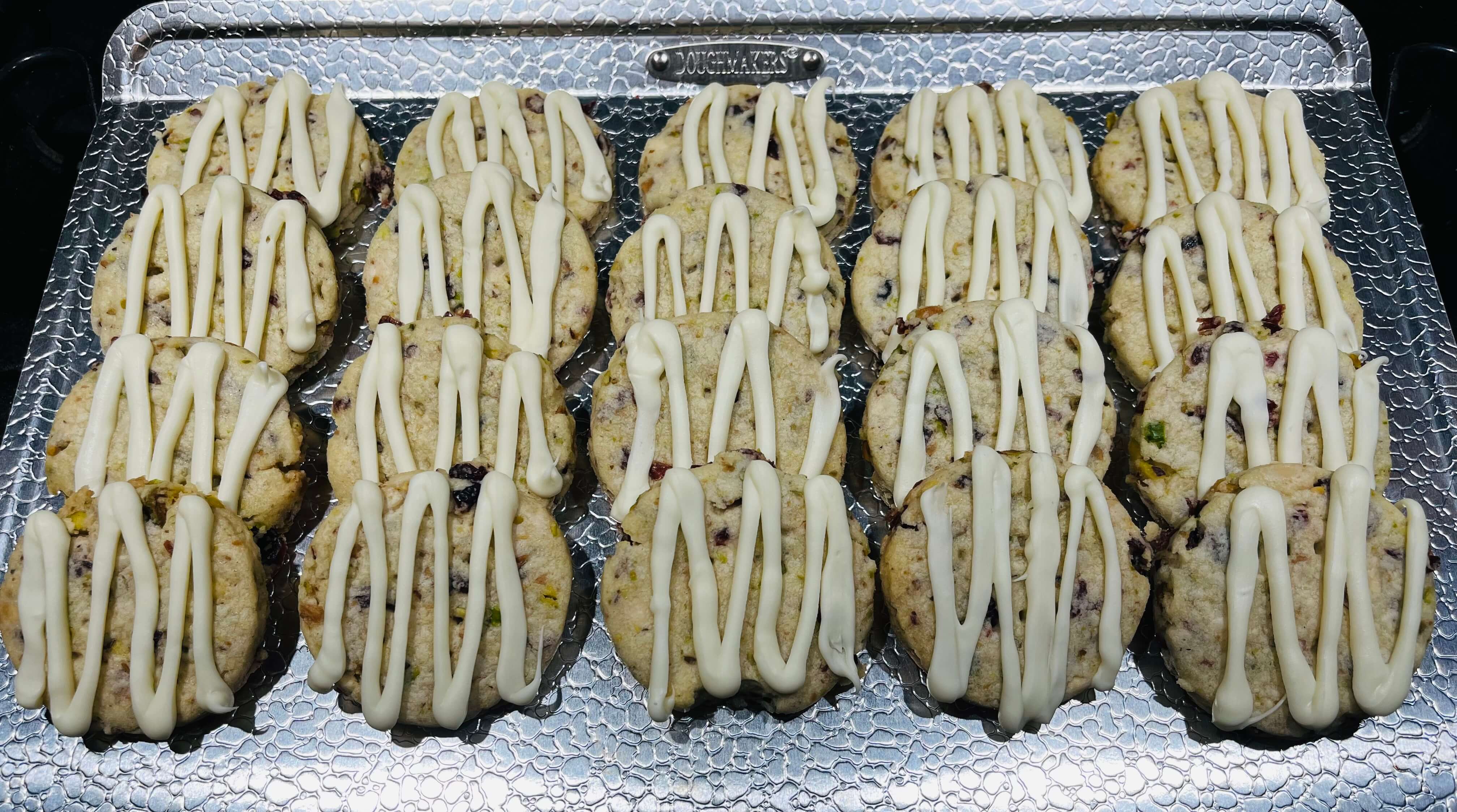 Shortbread cookies mixed with cranberries, pistachios, and white chocolate morsels, topped with more white chocolate.