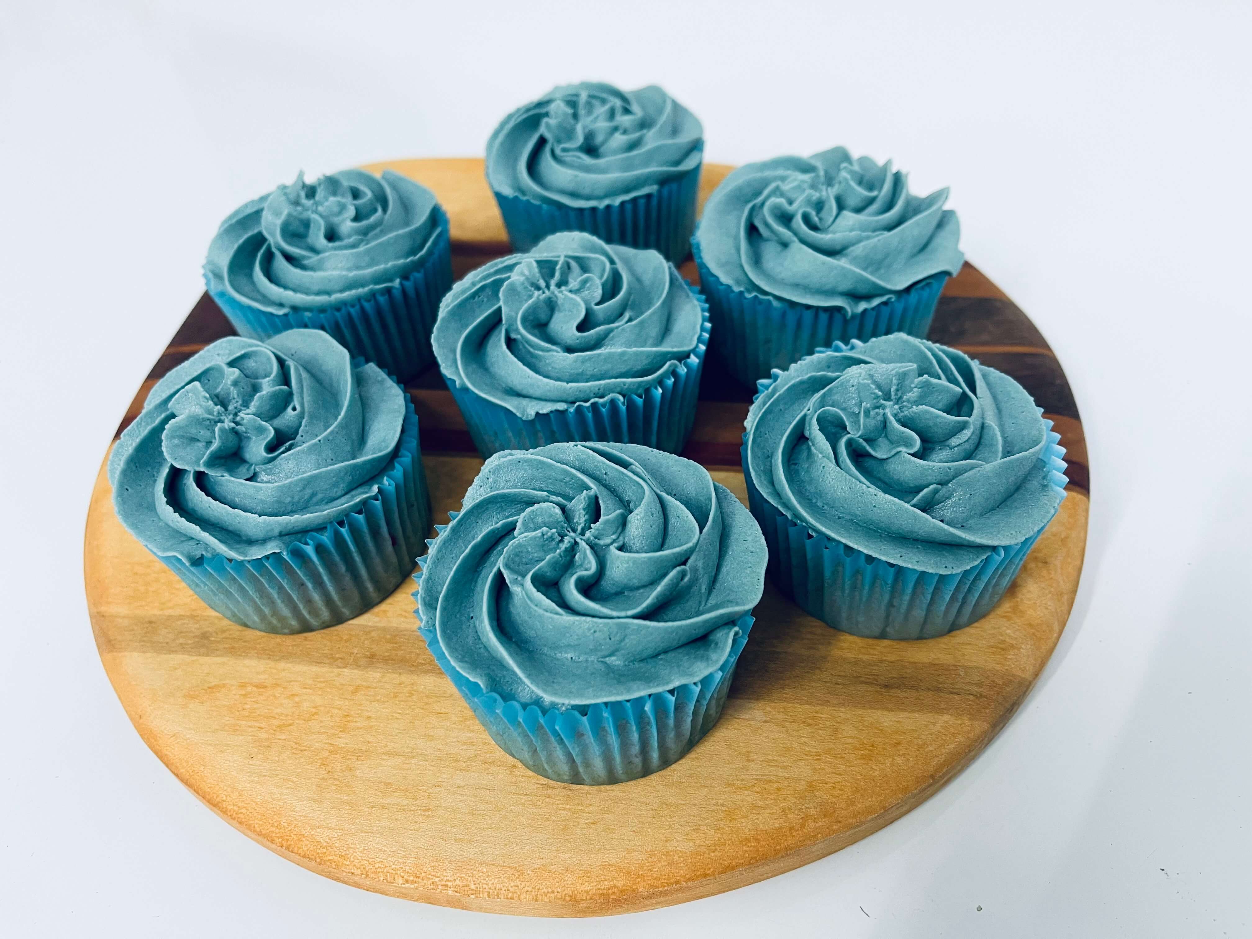 Decorated vanilla cupcakes with vanilla frosting swirled on top