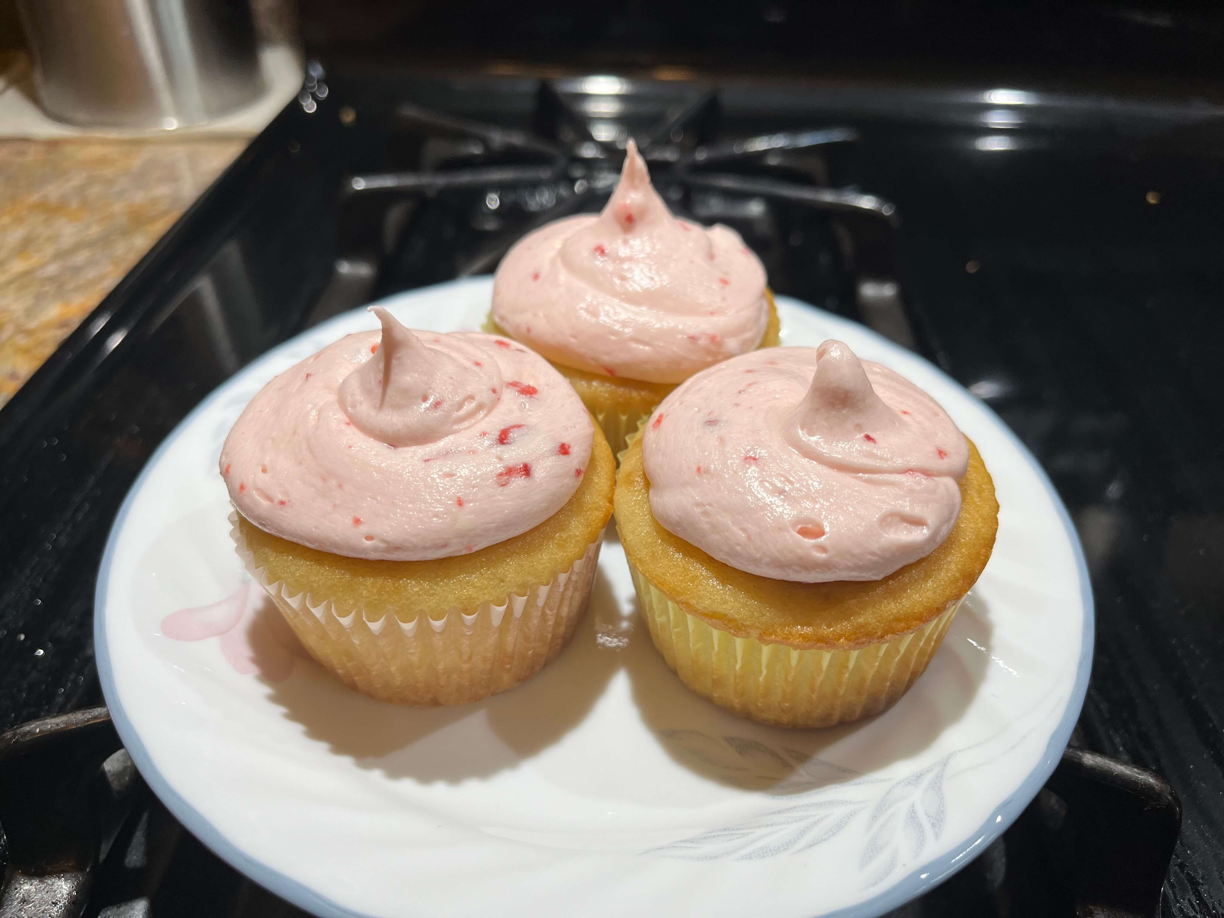 Egg-free strawberry cupcakes filled with jam and topped with strawberry Swiss buttercream.